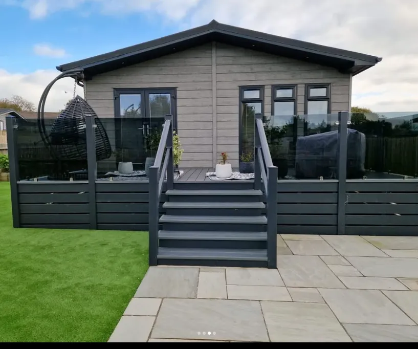 Wrap-around grey composite deck with glass balustrade in Exmouth