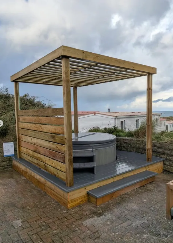 Hot tub with timber pergola and privacy screen in Sidmouth